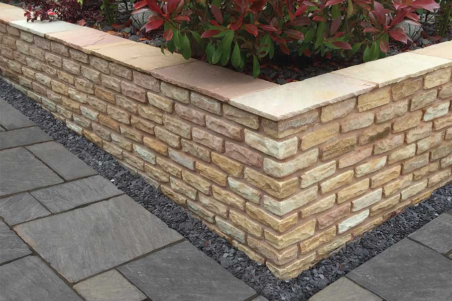 Lovely retaining garden wall built with AWBS Coastal Mix sandstone walling stone